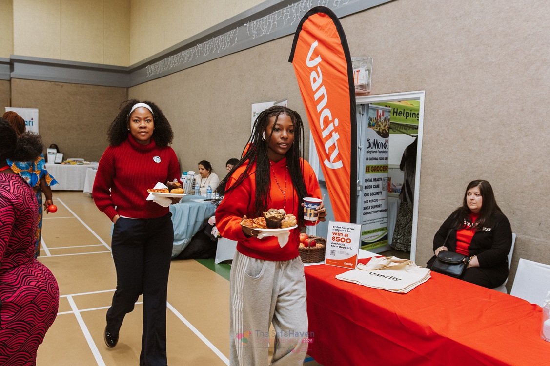 Two women walking through the community resource booths at a previous Safe Haven Conference